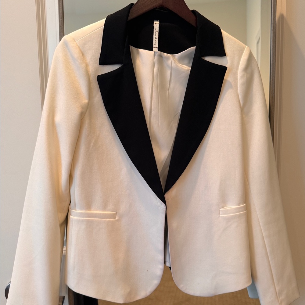Women’s cream and black “tuxedo” style blazer.